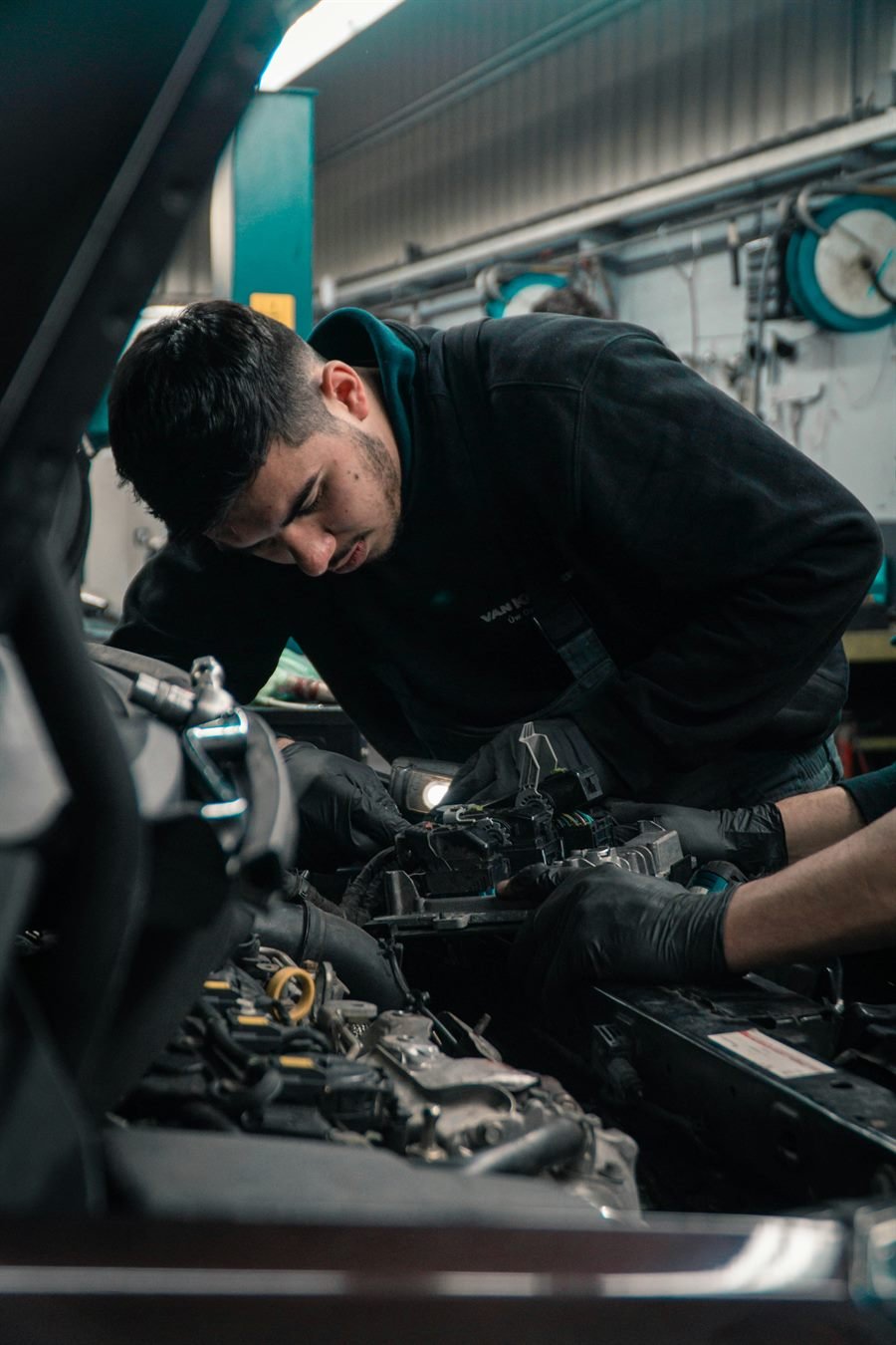 Dallas Auto Repair Pros mobile mechanic diagnosing a car under the hood in Dallas, TX