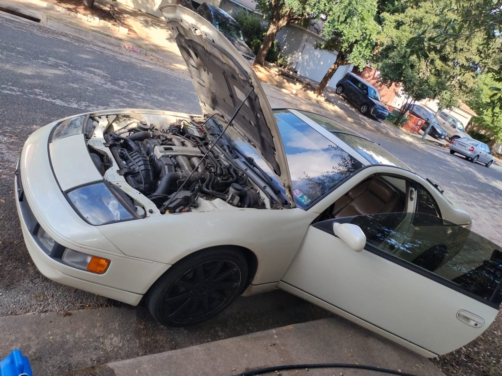 Mobile mechanic working on a car at a customer's home in Dallas